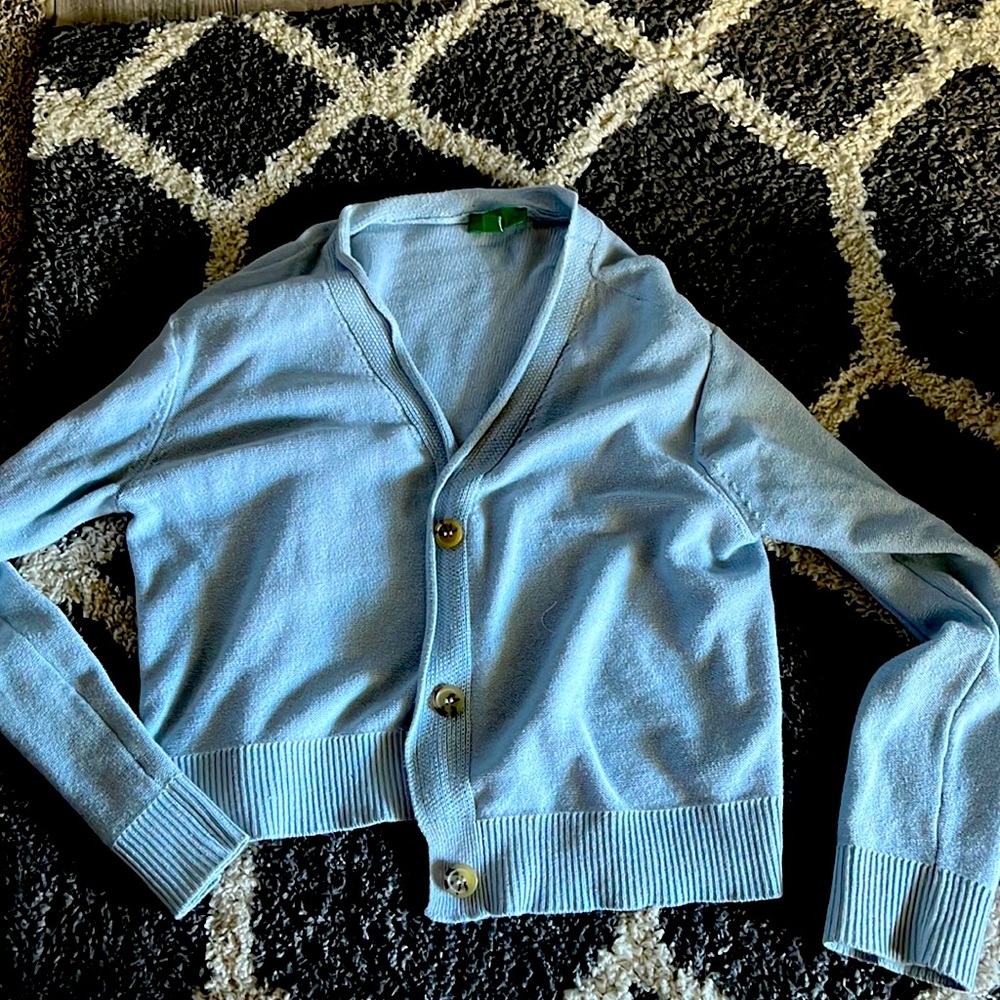 Small blue sweater with accent buttons